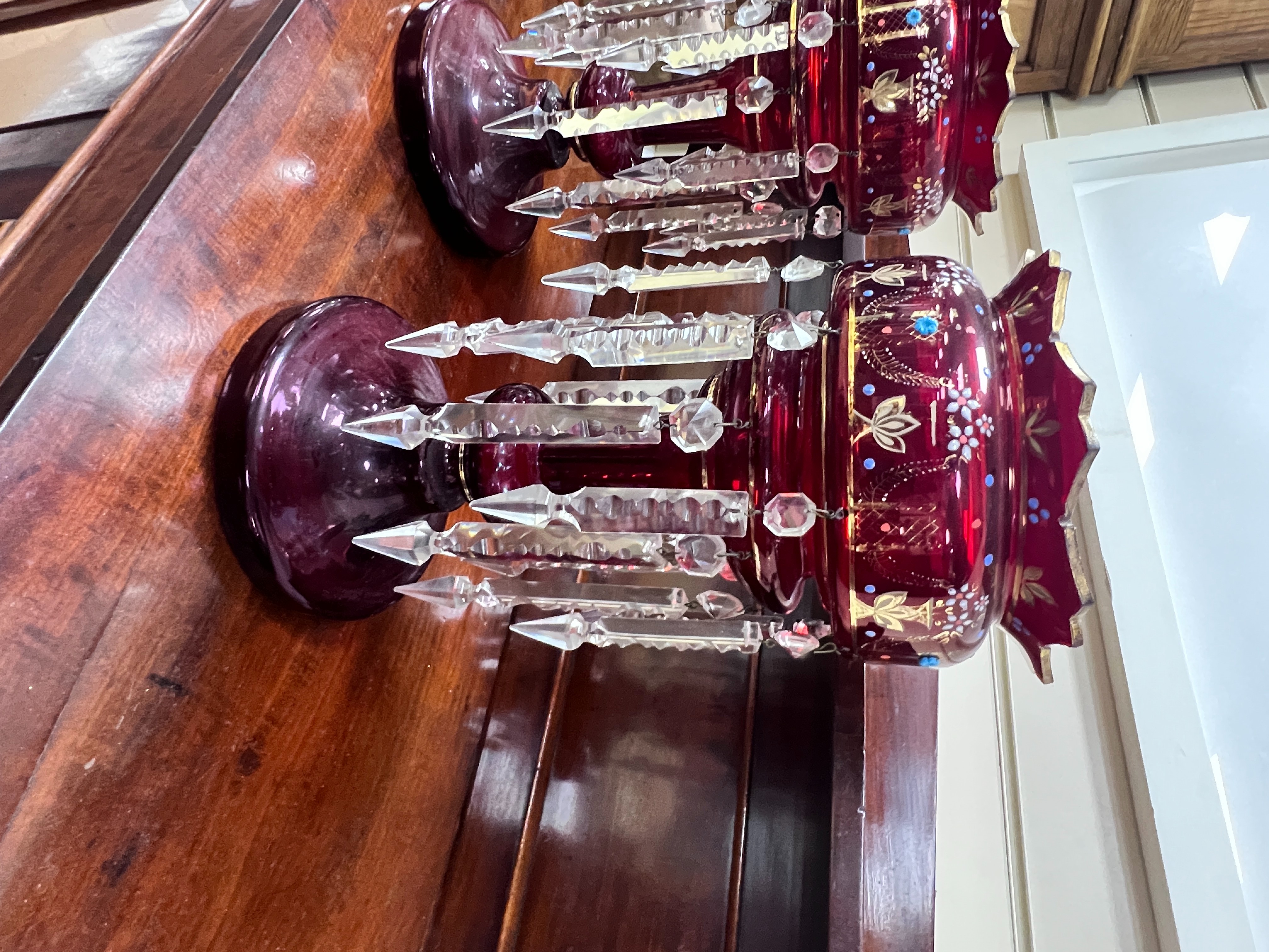 A pair of Victorian ruby glass table lustres, 36 cms high